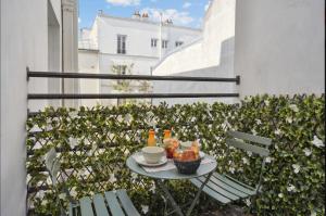 a table with a cup of coffee and food on a balcony at Eiffel Tower Apartment/Invalide by Studioprestige in Paris