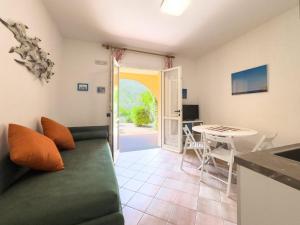 a living room with a couch and a table at Appartamento Stefania Località Nisportino in Rio nellʼElba