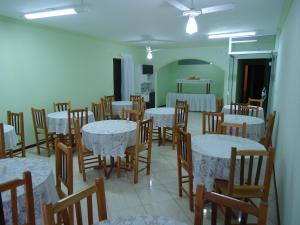 a dining room with tables and chairs in a room at Iria's Hotel in Timbó