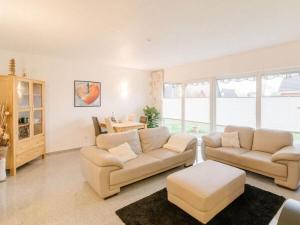 a living room with two couches and a table at Nordzeeoase-Pethan met sauna in Neuharlingersiel