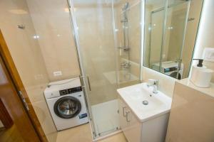 a bathroom with a washing machine and a washer at Apartment Riva Parenzo in Poreč +23 photos