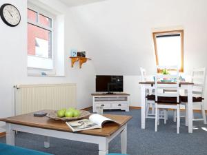 a living room with a table and a dining room at House in Legde "East" in Norderney