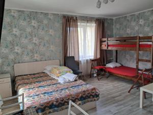 a bedroom with a bed and a bunk bed at Sparta Apartments Kosmonaudi in Narva