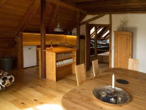 a dining room with a table and a kitchen at Landgoed Vier Seizoenen in Wangen im Allgäu +13 photos