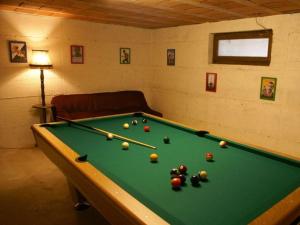 a room with a pool table with balls on it at Les Petits Vignerons in Cleebourg +20 photos