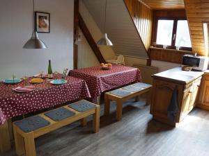 a dining room with a table and a table and chairs at Les Petits Vignerons in Cleebourg
