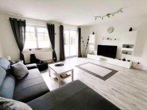 a living room with a couch and a table at Holiday home Heide Comfortable holiday residence in Bad Fallingbostel