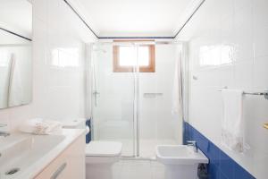 a bathroom with a shower and a toilet and a sink at Blancazul Avenida in Playa Blanca +27 photos