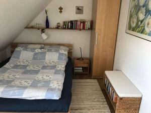 a bedroom with a bed and a bench in it at Haus Butje Comfortable holiday residence in Fedderwarderdeich