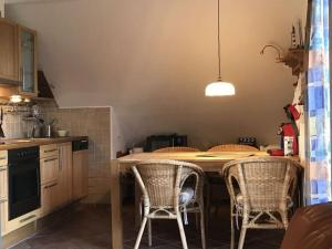 a kitchen with a table and chairs in it at Haus Butje Comfortable holiday residence in Fedderwarderdeich