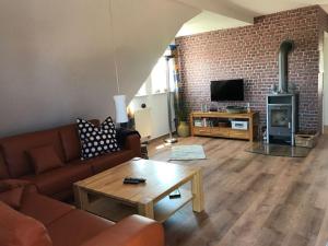 a living room with a couch and a table at Haus Butje Comfortable holiday residence in Fedderwarderdeich