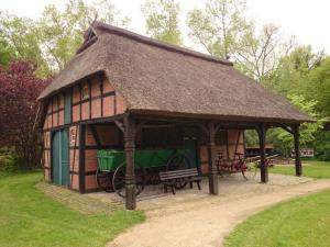 a large wooden building with a bench in a park at Taubenweg 19 Comfortable holiday residence in Fintel