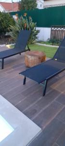 two ping pong tables sitting on top of a patio at Poolemonhouse in Fernao Ferro
