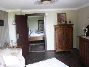 a room with a bedroom with a bed and a mirror at Country house Messerschmitt in Böchingen