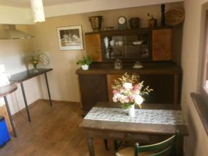 a dining room with a table with flowers on it at Country house Messerschmitt in Böchingen +10 photos