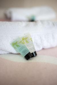 a bottle of moisturizing cream sitting on top of a towel at Coastal Haven in Leigh-on-Sea in Southend-on-Sea