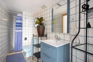 a bathroom with a blue sink and a toilet at OkStay Las Teresitas Tenerife Casa cueva in Güimar +19 photos