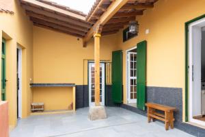a porch of a house with a wooden roof and a bench at OkStay Las Teresitas Tenerife Casa cueva in Güimar