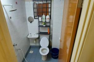 a small bathroom with a toilet and a sink at KLIA Minimalist Gr Fl Villa w free park & TV in Sepang +16 photos