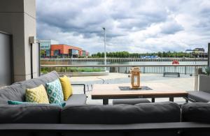 a living room with a couch and a coffee table at AC Hotel by Marriott Belfast in Belfast