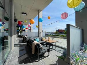 a patio with couches and a table and balloons at AC Hotel by Marriott Belfast in Belfast