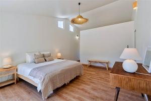 a white bedroom with a bed and a desk at Monte dos Figos · Charming Villa with Private Pool close to Comporta in Grândola