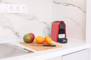 une planche à découper avec des pommes, des oranges et un grille-pain dans l'établissement Sol Apartments Corfu by Estia, à Corfou 48 autres photos