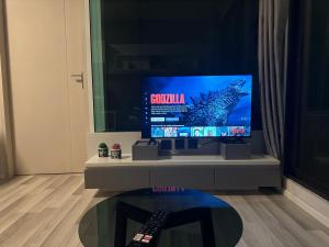 a tv sitting on a stand in a living room at Casa Bondia in Bangkok