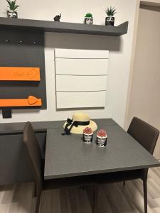 a table with a hat and two cupcakes on it at Casa Bondia in Bangkok +6 photos