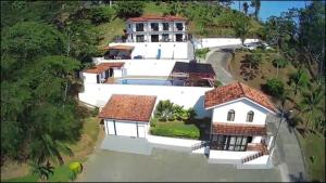 an aerial view of a large white house with a swimming pool at Hotel Los Cielos Del Caribe in Cahuita