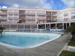 a hotel with a swimming pool in front of a building at St James Apartment in Luz