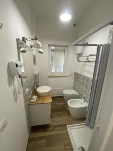 a bathroom with two sinks and a toilet at Garden City House in Rome