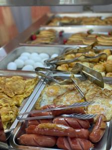 a buffet of food with hot dogs and other foods at Hotel Vila Misiri in Durrës