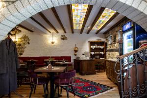a restaurant with tables and chairs in a room at Vista Boutique Hotel in Berat