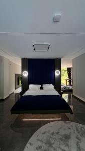 a bedroom with a large bed with a blue wall at Yesilvadi Otel 4M LUXURY in Ayder Yaylasi +61 photos