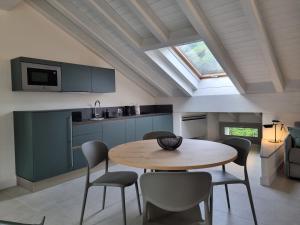 a kitchen and dining room with a table and chairs at Delago 1685 in Malgrate
