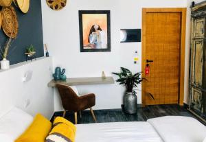a living room with a white couch and a wooden door at S'accabbadora Guest House in Alghero