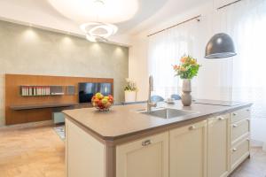 a kitchen with a sink and a counter top at Antico Borgo 7 - Elegant Apartment Walking Distance to Montepulciano Historic Centre in Montepulciano