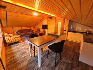 a kitchen and living room with a table and chairs at Danis Otel Ve Restoran in Uzungol