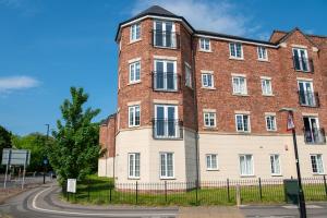 a large brick building with white windows at Spacious Retreat with Parking: Ideal for Families & Contractors in York