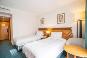 Ένα ή περισσότερα κρεβάτια σε δωμάτιο στο Azal Pyramids Hotel
