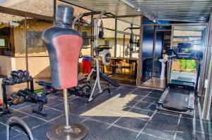 a room with a gym with a chair and weights at Riverstone Guest Lodge in Harare