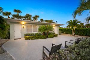 a villa with a driveway and a house at Boutique Vacation Rental Complex At Beach in Cocoa Beach