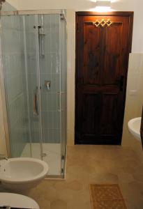 a bathroom with a shower and a sink and a toilet at Cala Sinzias beach house with stunning views in Costa Rei
