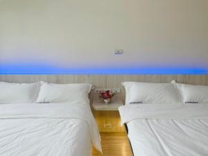 Krevet ili kreveti u jedinici u okviru objekta Penghu Roundabout Guesthouse