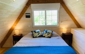 a bed in a small room with a window at Le Clos de Kermadec in Kervignac +91 photos