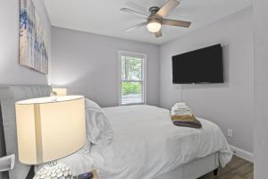 a bedroom with a bed and a flat screen tv at Duplex Hideaway in Saint Charles MO in St. Charles