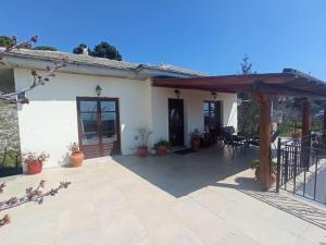 a patio of a house with a wooden pergola at Christina's House - Neochori / Pelion in Neochori