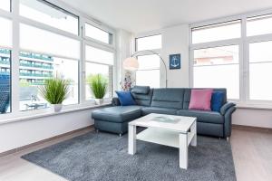 ein Wohnzimmer mit Sofa und Tisch in der Unterkunft Passagendeck Nordseegartenpark in Bensersiel