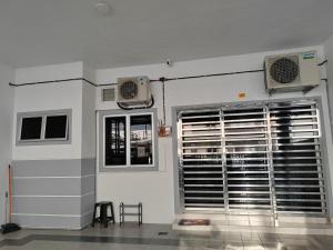 a room with two air conditioners and a window at My Homestay Sitiawan - Astronaut Space House 8 Pax in Sitiawan